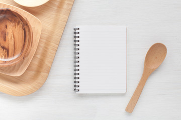 Empty notebook and kitchen utensils for food recipes..