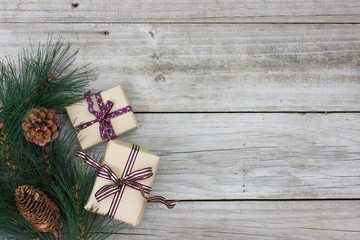 Brown paper packages and garland on rustic wood background