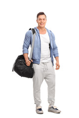 Poster - Young sportsman carrying a sports bag