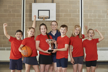 Wall Mural - Victorious School Sports Team With Trophy In Gym