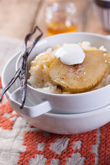 Wall Mural - Rice with milk, cinnamon, honey, pear and yoghurt with  in a white bowl.