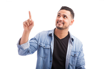 Wall Mural - Young man pointing up