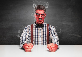 angry genius furious on blackboard background