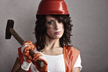 Wall Mural - Sexy girl in safety helmet holding hammer tool