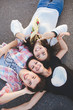 © kegfire - Three happy teenage friends lying together and laughing. Top view. Best friends.