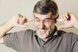 © triocean - I can not hear you!Close up portrait of a senior man with his fingers in ears