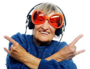 Funny old lady listening music and showing thumbs up. 