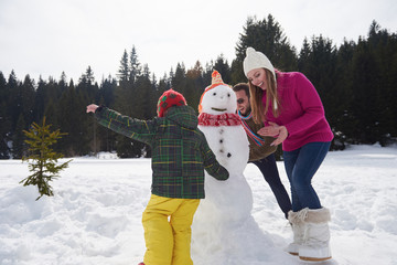 Canvas Print - happy family building snowman