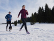 yougn woman jogging outdoor on snow in forest