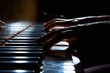 Woman's hands on the keyboard of the piano in night closeup
