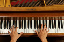 Woman's Hands On The Keyboard Of The Piano Closeup