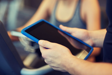 Sticker - close up of trainer hands with tablet pc in gym