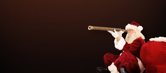 Canvas Print - Composite image of santa claus looking through telescope