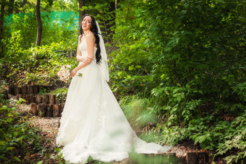  Bride in wedding dress in forest