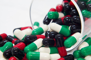 Wall Mural - Red black and Green white capsules with a grass cup