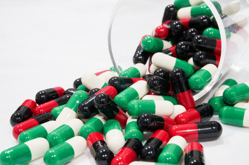 Wall Mural - Red black and Green white capsules with a grass cup