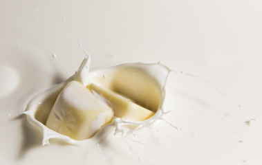 white chocolate falls in milk