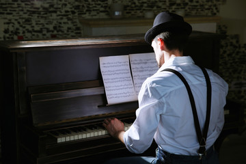 Poster - Handsome young man in hat making piano music