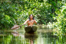 Amazon Tribe Brazil Indian Ecuador Indigenous Native Village People Culture Forest Indigens Mature Male On Symbolic Wooden Boat Chopped From A Single Timber Cruising Murky Waters Of Ecuadorian Amazon