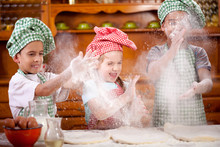 Three Funny Young Child Shaking Hands With Flour In The Kitchen