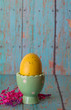 Yellow Easter Egg in a Pastel Green Egg Holder