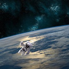 Wall Mural - an astronaut floats above earth - elements of this image furnished by nasa.