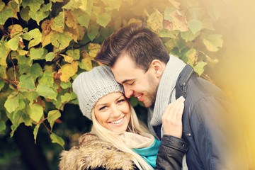 Wall Mural - Young romantic couple in the park in autumn