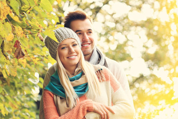 Wall Mural - Young romantic couple in the park in autumn