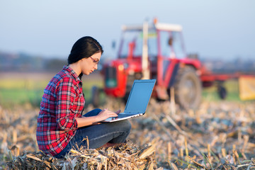 Wall Mural - Woman with laptop in corn field