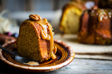 Wall Mural - Homemade autumn cake with nuts and caramel on wooden background