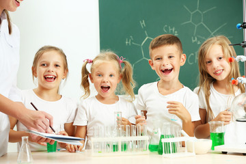 Wall Mural - Cute pupils doing biochemistry research in chemistry class