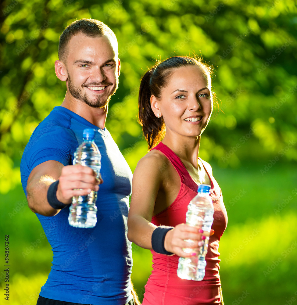 Man and woman drinking water from bottle after fitness sport exercise Stock  Photo | Adobe Stock, image size:974x1000