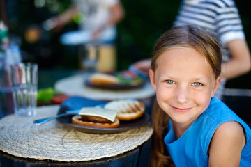 Canvas Print - Little girl eating burger