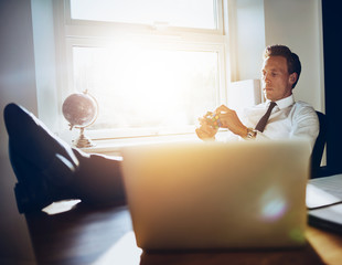 white executive business man sitting at his desk getting inspiration