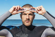 © santypan - handsome swimmer putting on goggles