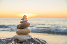 Stones Pyramid On Sand Symbolizing Zen, Harmony, Balance. Ocean