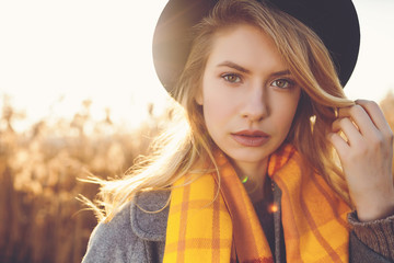 Portrait of romantic girl in a field in sunset light. winter, autumn life