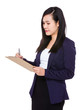 © leungchopan - Asian Businesswoman take note on clipboard