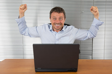 Wall Mural - Excited businessman with arms up