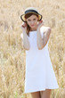 © triocean - Outdoor portrait of girl in the white dress holding straw hat