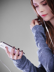 Wall Mural - young woman with smart phone listening music