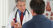 Doctor Explaining Heart To Elderly Patient