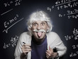© de Art - Funny portrait of a mad geek scientist who like Einstein shows protruding tongue against the background of a blackboard with formulas