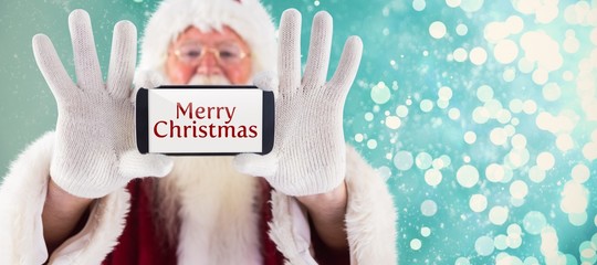 Canvas Print - Composite image of santa records himself with a smartphone