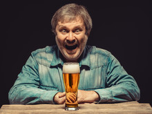 The Smiling Man In Denim Shirt With Glass Of Beer