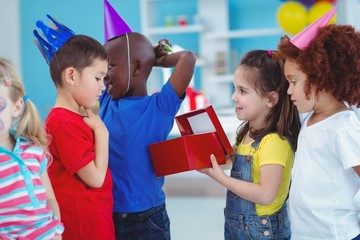 Wall Mural - Happy girl opening a present