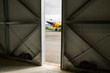 © nikhg - Aereo bimotore visto dall'interno di un hangar