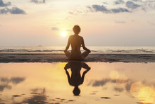 Silhouette Meditation Girl On The Background Of The Stunning Sea And Sunset. Yoga, Fitness And Healthy Lifestyle.