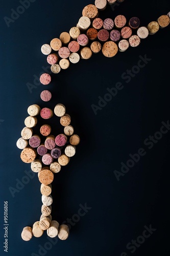 Filling a glass of wine from the bottle made by cork vertical Canvas Print