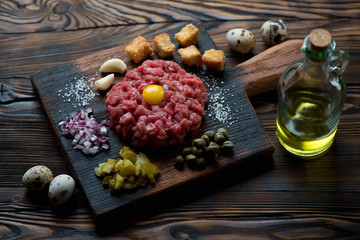 Wall Mural - Beef tartare with egg yolk, capers, sliced pickles and onion